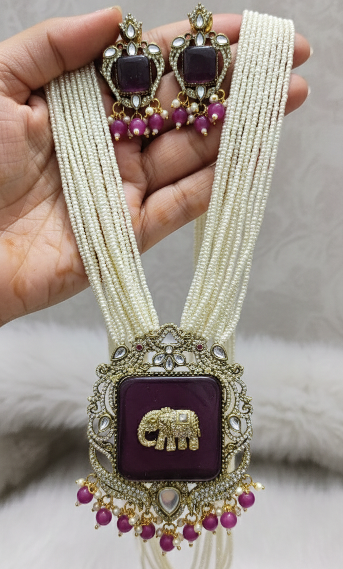 Traditional Indian jewelry set with a necklace and earrings on a white background
